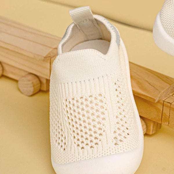 White breathable mesh baby sneakers close-up texture